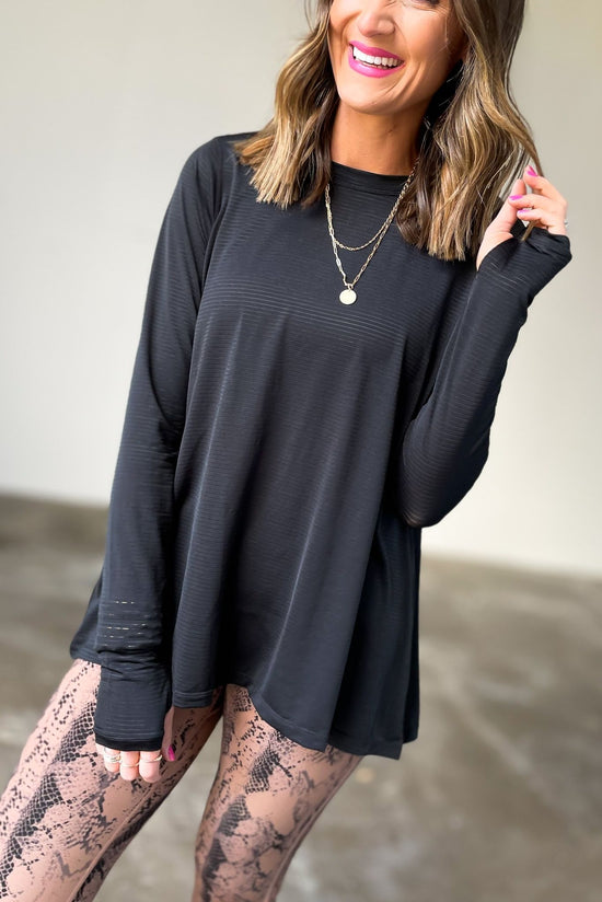 Load image into Gallery viewer, black long sleeve ribbed top with cut out back, affordable athleisure, fitness fashion, shop style your senses by mallory fitzsimmons
